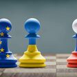 Ukraine, EU and Russia conflict. Country flags on chess pawns on a chess board. 3D illustration.