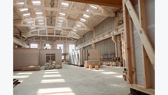 House under construction with white floor, building materials, construction cabins and ceiling with windows