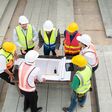 Construction engineers, architects, and foremen form a group. Participate in a meeting to plan new construction projects.