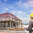 Professional engineer architect worker with protective helmet and blueprints paper at house building construction site background