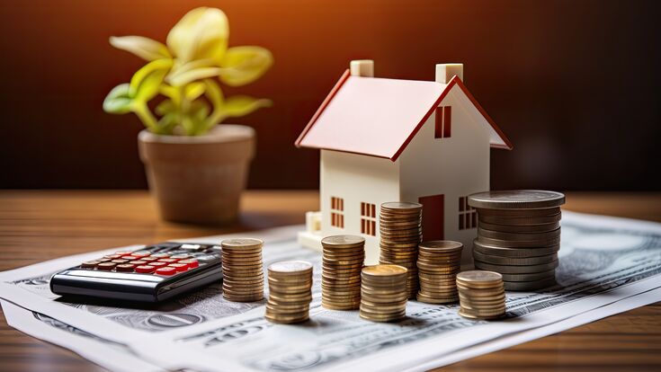 The idea of a home loan, represented by a paper application form, along with a money coin and a model of a house, placed on a table. This represents the financial aspect of loans for real estate