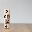 2024 Happy New year background banner. 2023 on wooden block cube for preparation new year change and start new business target strategy concept. Welcome, Merry Christmas.