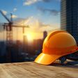 Construction helmet on a blurred background of a construction site at sunset. AI generated