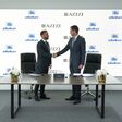 Signing ceremony Farhad Azizi left Robert Hauser right Azizi Developments
