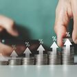 Interest rate and dividend concept. Businessman stacking coins money with up arrow and percentage symbol for financial banking increase interest rate or mortgage investment dividend business growth.