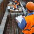 construction, worker, site, safety, hard hat, vest, orange, clipboard, documents, building, industry, engineering, teamwork, progress, development, infrastructure, project, plan, blueprint, inspection, quality control, management, supervision, architecture, contractor, engineer, foreman, job site, construction worker, construction site, safety gear, safety vest, construction safety, building site, urban development, industrial, occupation, profession, career, job, work, employee, labor, manual labor, skilled worker, expertise, professionalism