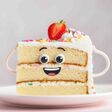 Playful cartoon face on strawberry topped vanilla layer cake slice with sprinkles.